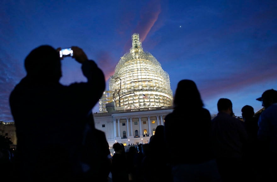 The sun rising as people gather on Capitol Hill in Washington, D.C., Sept. 24, 2015, for a chance to see Pope Francis. (Patrick Semansky/AP Images)