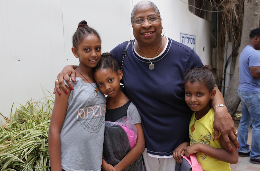 Rev. Deedee Coleman of Russel Street Missionary Baptist Church in Detroit posing with African migrant children in Tel Aviv. Aug. 30, 2015.