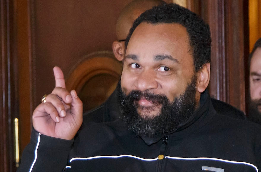French comedian Dieudonne M'Bala M'Bala gesturing to the media as he leaves a Paris court house, Feb. 4, 2015. (Michel Euler/AP Images)