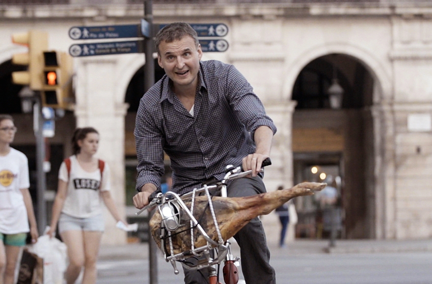 Rosenthal, biking with a ham in Barcelona, in a scene from 