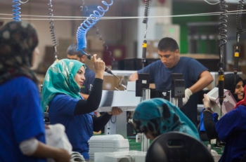 Employees working at the new SodaStream factory built deep in Israel's Negev Desert next to the city of Rahat, Israel, that will replace the West Bank facility when it shuts down in two weeks time, Sept. 2, 2015. (Dan Balilty/AP Images)