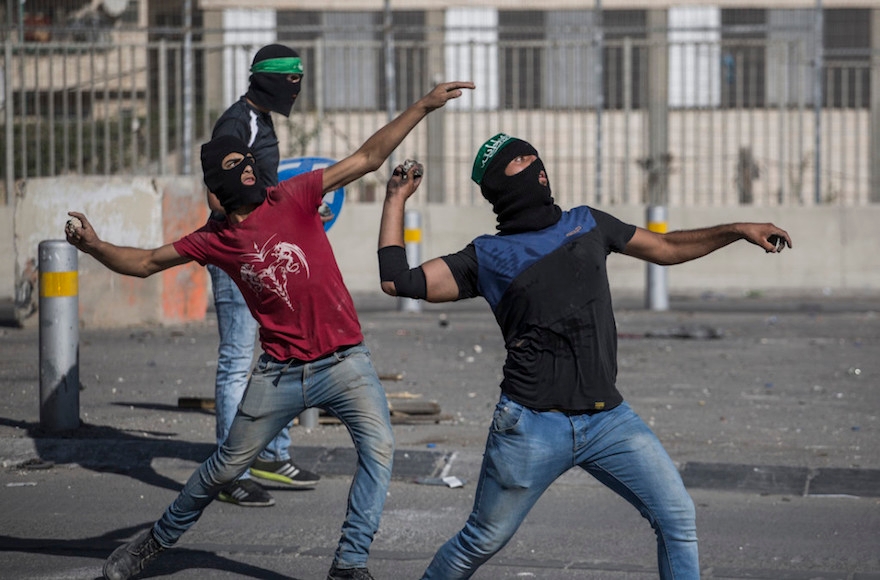 Palestinians throwing rocks at Israeli police during clashes in eastern Jerusalem, Sept. 18, 2015. (Hadas Parush/Flash90)