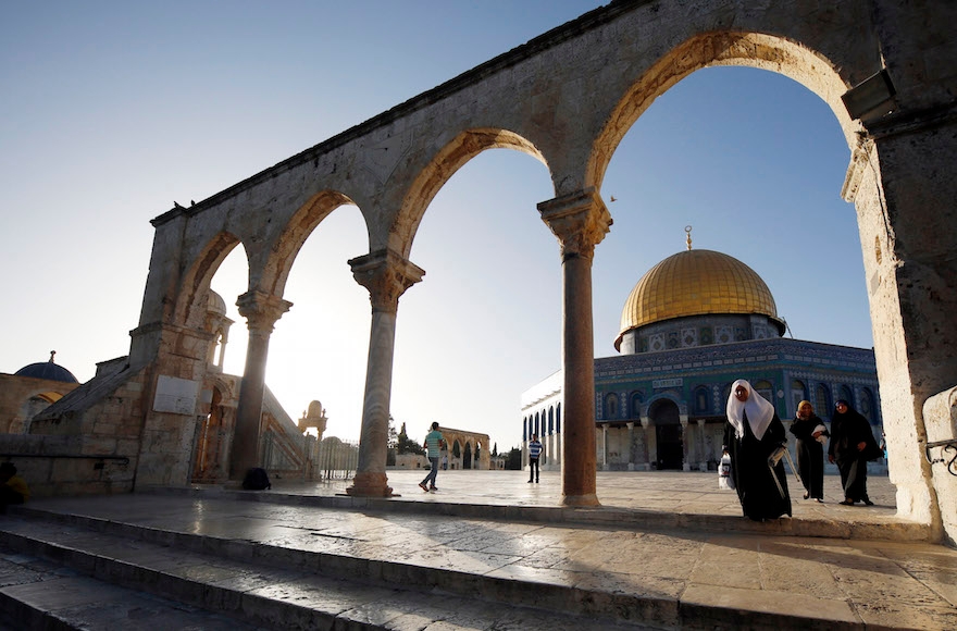 Muslims walking by the Al-Aqsa Mosque, in Jerusalem's Old City, on their way to pray on the second day of the holy Muslim month of Ramadan, Jun 30 2014. (Sliman Khader/Flash90)