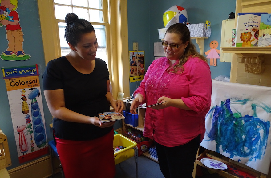 Lisa Fuentes, a home visit coordinator, left, and the Family Place Executive Director Haley Wiggins reviewing training material. (Suzanne Pollak)