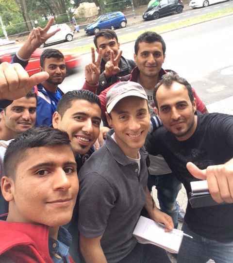 Some of the Syrian refugees interviewed in Berlin insisted on taking selfies with JTA's Uriel Heilman, in Yankees cap. (Uriel Heilman)