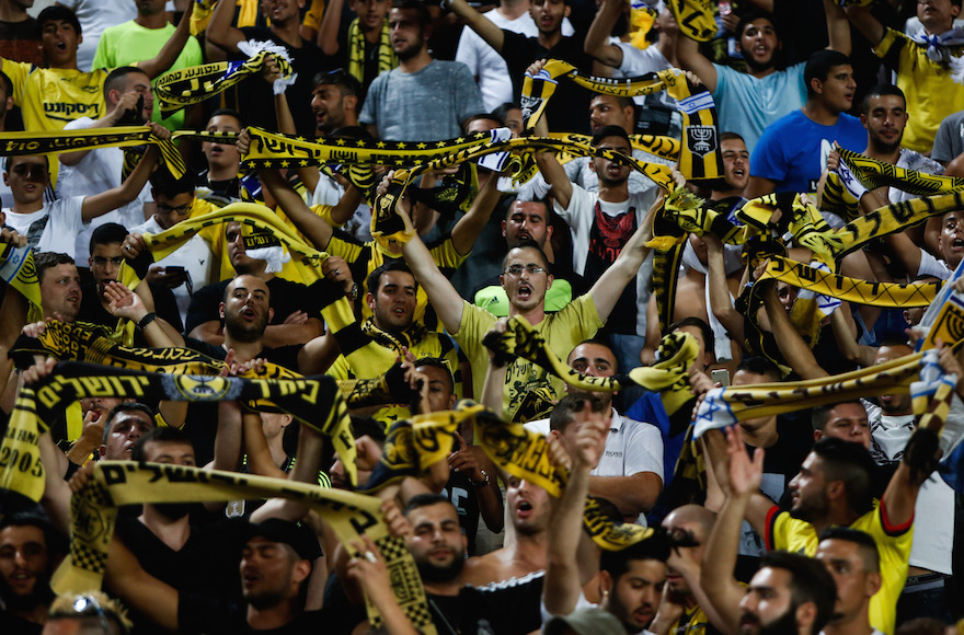 Beitar Jerusalem fans cheer ing at a match at Teddy Stadium in Jerusalem, July 23, 2015. (Yonatan Sindel/Flash90).