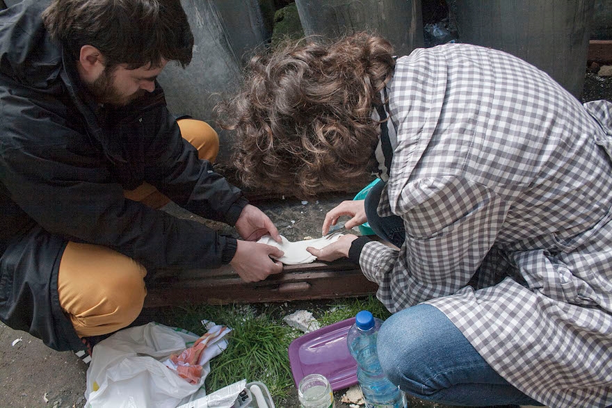 Helena Czernek and Aleksander Prugar making a plaster cast from the impression left by a mezuzah. (Katarzyna Markusz)