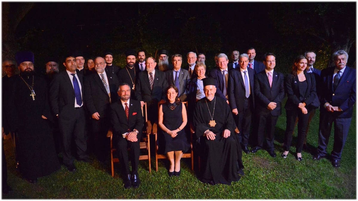 Jewish and Orthodox Christian clerics and scholars posing with the Israeli ambassador to Greece, Irit Ben-Abba, at an interfaith dialogue commemorating 25 years of formal relations between Israel and Greece. (Embassy of Israel in Athens)