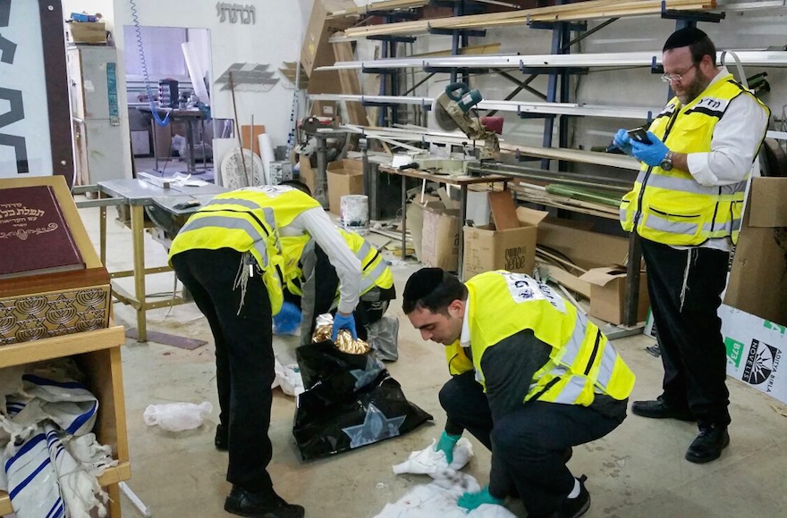 ZAKA personnel cleaning the scene where two Israelis were killed and at least two others wounded in a stabbing attack in southern Tel Aviv , November 19, 2015. (Moti Karelitz/ZAKA Tel Aviv) 