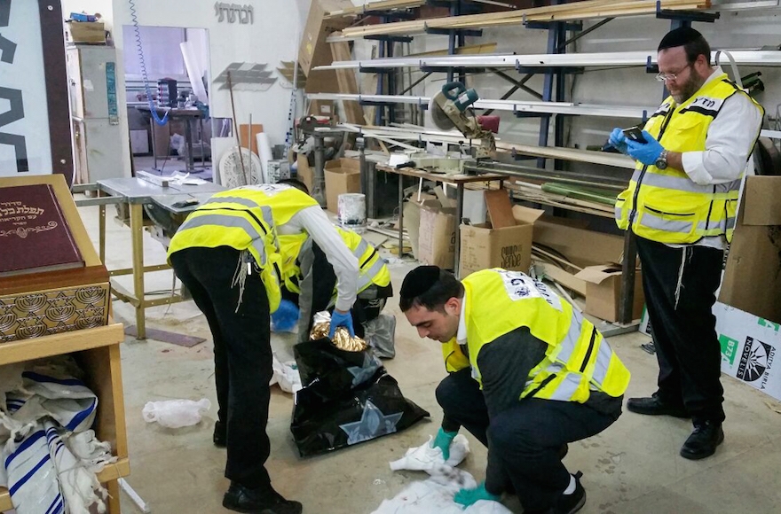 ZAKA personnel cleaning the scene where two Israelis were killed and at least two others wounded in a stabbing attack in southern Tel Aviv , November 19, 2015. (Moti Karelitz/ZAKA Tel Aviv)