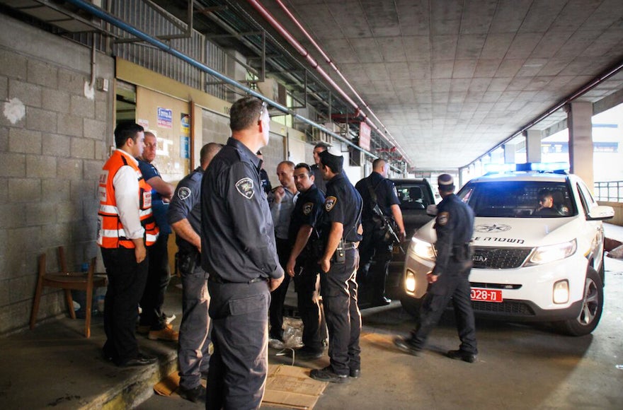 Israeli police at the scene where two Israelis were killed and at least two others wounded in a stabbing attack in southern Tel Aviv, Nov. 19, 2015. (Moti Karelitz/ZAKA Tel Aviv) 