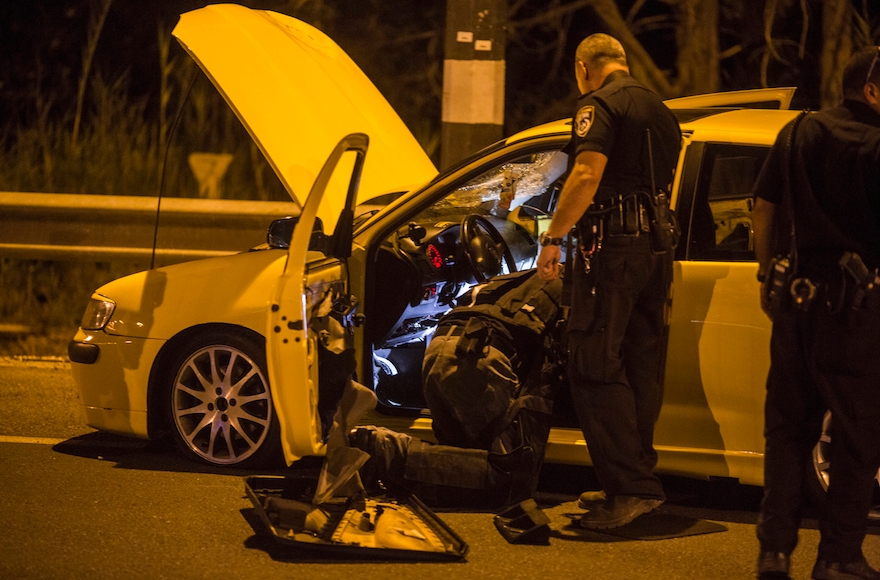 Police at the site of a suspected terror attack by an Israeli Arab who allegedly drove his car into four Israeli's on Oct. 11, 2015 in Gan-Shmuel, Israel. (Ilia Yefimovich/Getty Images)
