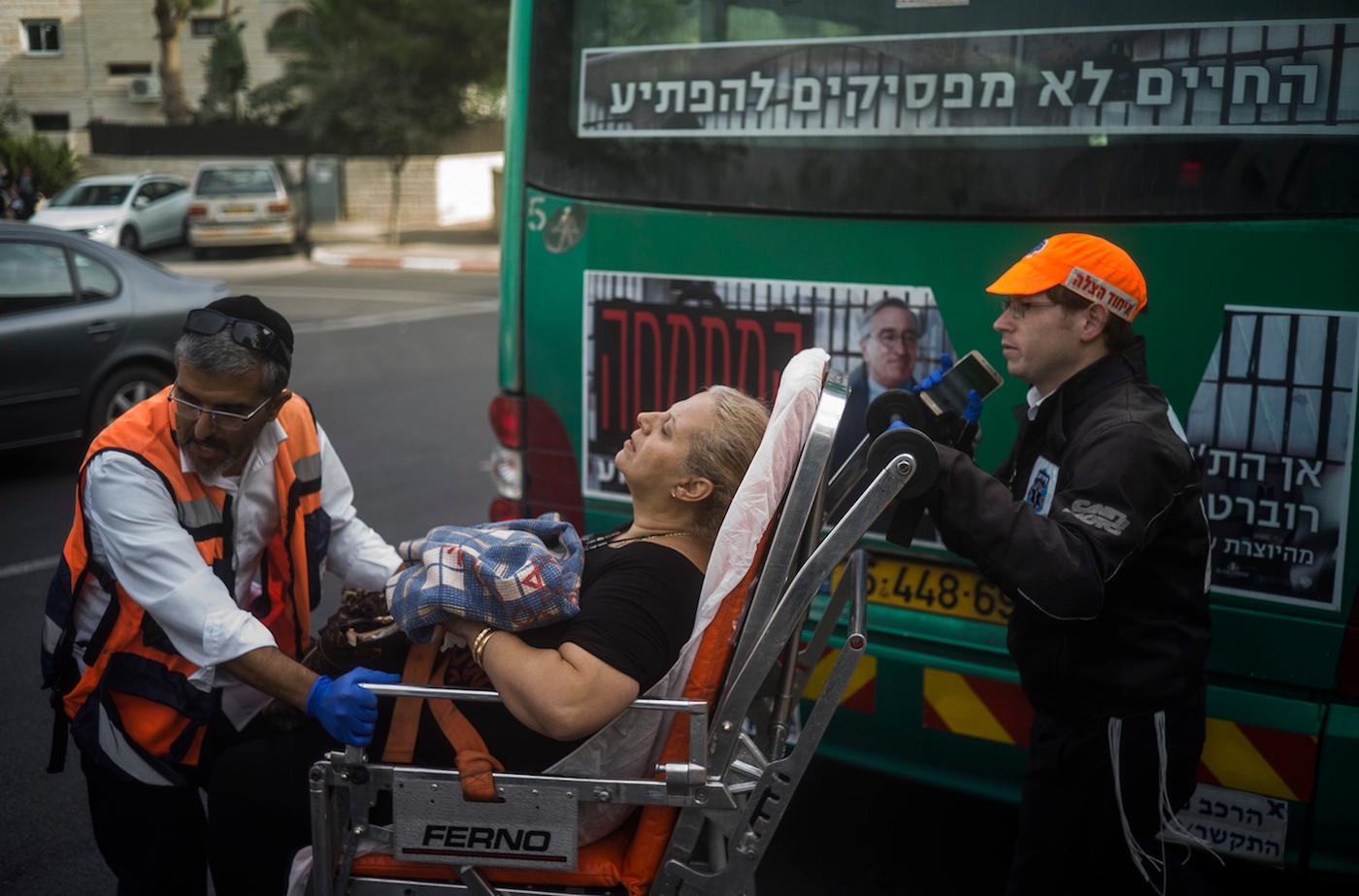 An injured woman being transferred to a hospital after a Palestinian man attacked passengers on a bus in Jerusalem, Oct. 12, 2015. (Ilia Yefimovich/Getty Images)