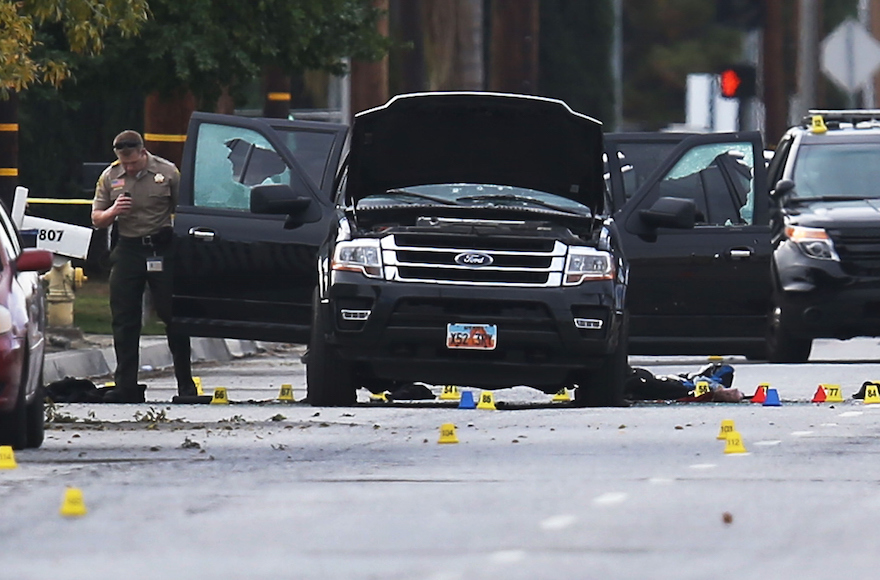 Law enforcement officials investigating the Ford SUV vehicle at scene of the shooting at the Inland Regional Center in San Bernardino, California, Dec. 3, 2015. (Joe Raedle/Getty Images)