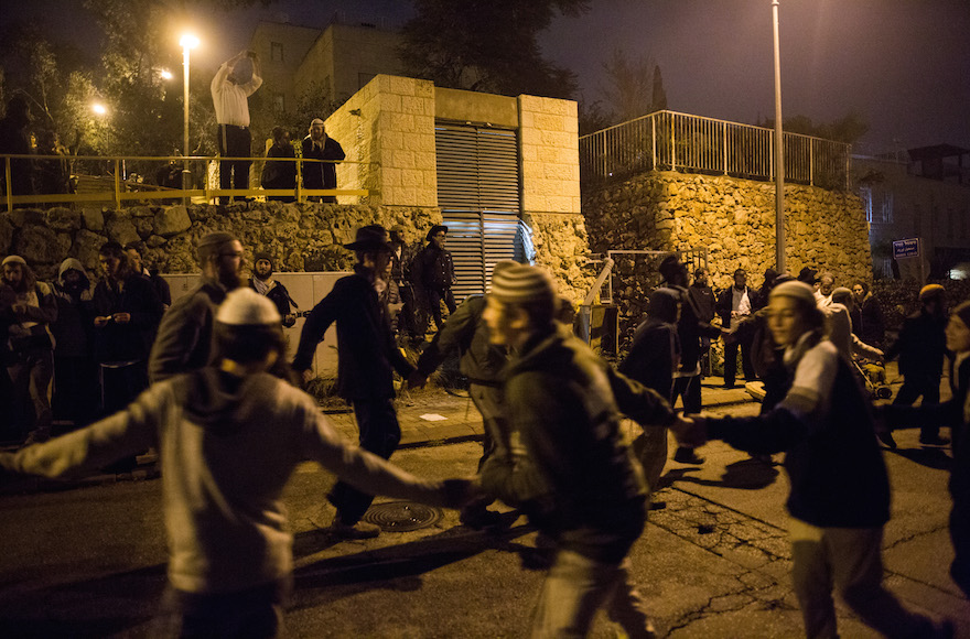 Right-wing activists dancing as they protest the detention of Jewish youth in the Duma terror attack investigation near the house of Shin Bet chief Yoram Cohen in Jerusalem, Israel, Dec. 19, 2015. (Yonatan Sindel/Flash90)