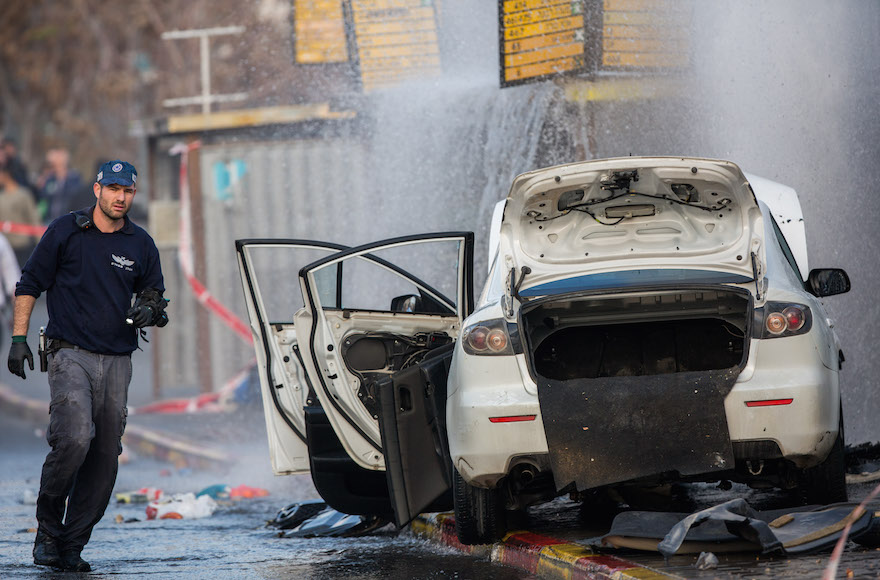 Israeli security personnel at the scene where a Palestinian driver rammed his car into a bus stop injuring about 13 people who were waiting there, on Herzl Boulevard at the entrance to the city of Jerusalem, Dec. 14, 2015. (Yonatan Sindel/Flash90)