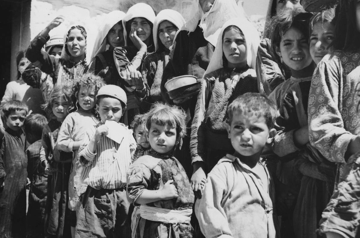 Palestinian refugees line up for food at a camp in Amman, Jordan in 1955. (Three Lions/Getty Images)