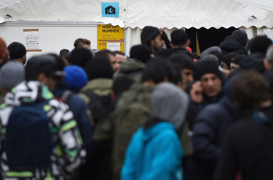 Migrants queuing next to a tent at the State Office of Health and Social Affairs in Berlin, Germany, Jan. 27, 2016. (Tobias Schwarz/AFP/Getty Images)