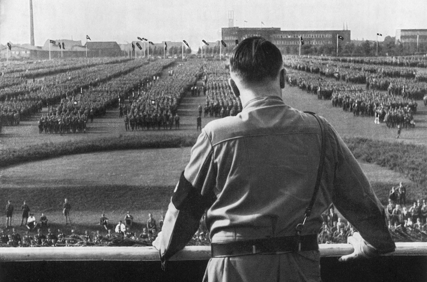 German Fuhrer and Nazi leader Adolf Hitler addressing soldiers with his back facing the camera at a Nazi rally in Dortmund, Germany. (Hulton Archive/Getty Images)