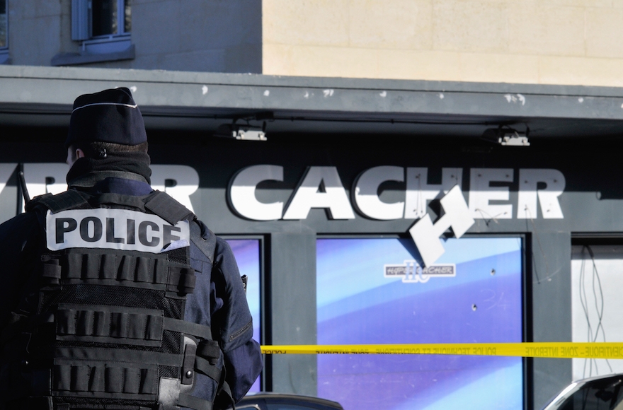 Security standing guard outside the kosher supermarket in Paris, where two days ago, four Jewish men were murdered when held hostage by an Islamist gunman, Jan. 11, 2015. (Serge Attal/Flash90)