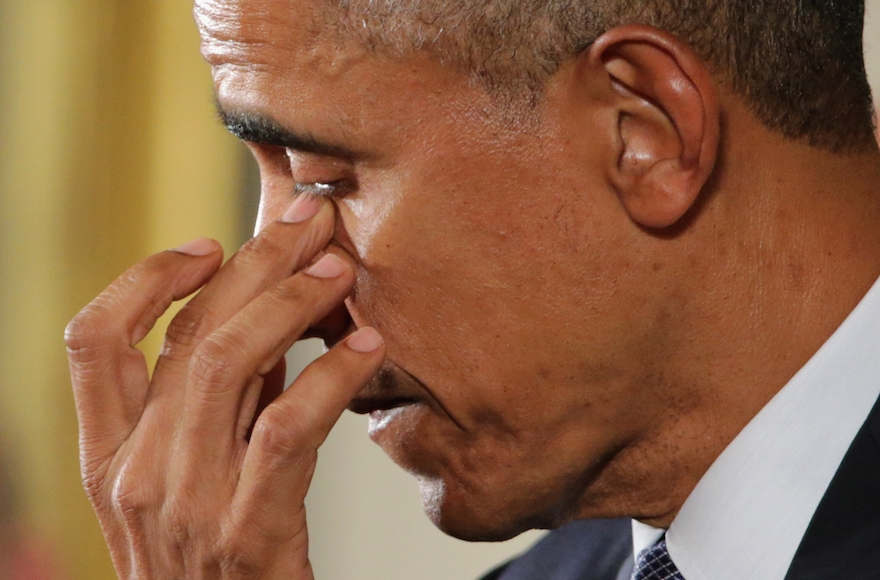 President Barack Obama wiping away tears as he talks about the victims of the 2012 Sandy Hook Elementary School shooting and about his efforts to increase federal gun control in the East Room of the White House in Washington, D.C., Jan. 5, 2016. (Chip Somodevilla/Getty Images)