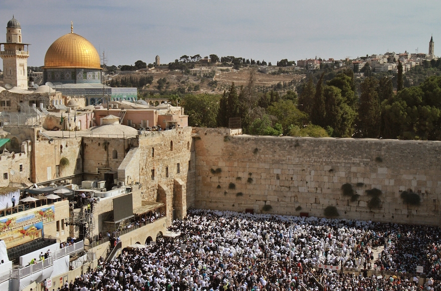 Jewish worshippers draped in prayer shawls performing the annual Priestly Blessing during Sukkot at the Western Wall in the Old City of Jerusalem, Israel, Sept. 30, 2015. (Gil Cohen/AFP/Getty Images)