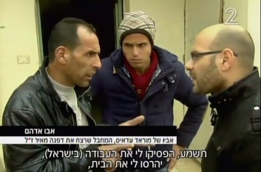 Abu Adham, left, the father of the Palestinian teen arrested on suspicion of killing Dafna Meir in her home. (Screenshot from Channel 2)