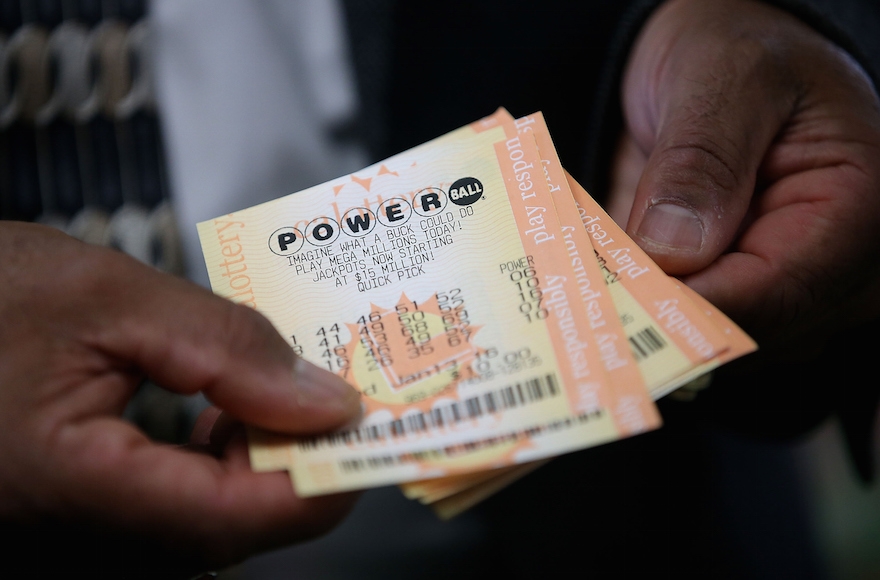 A customer holding Powerball tickets in San Lorenzo, California, Jan. 12, 2016. (Justin Sullivan/Getty Images)