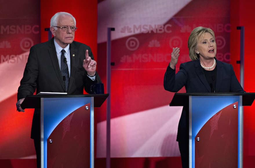 Hillary Clinton speaking as Senator Bernie Sanders listens during the Democratic presidential candidate debate at the University of New Hampshire in Durham, New Hampshire, Feb. 4, 2016. (Andrew Harrer/Bloomberg)