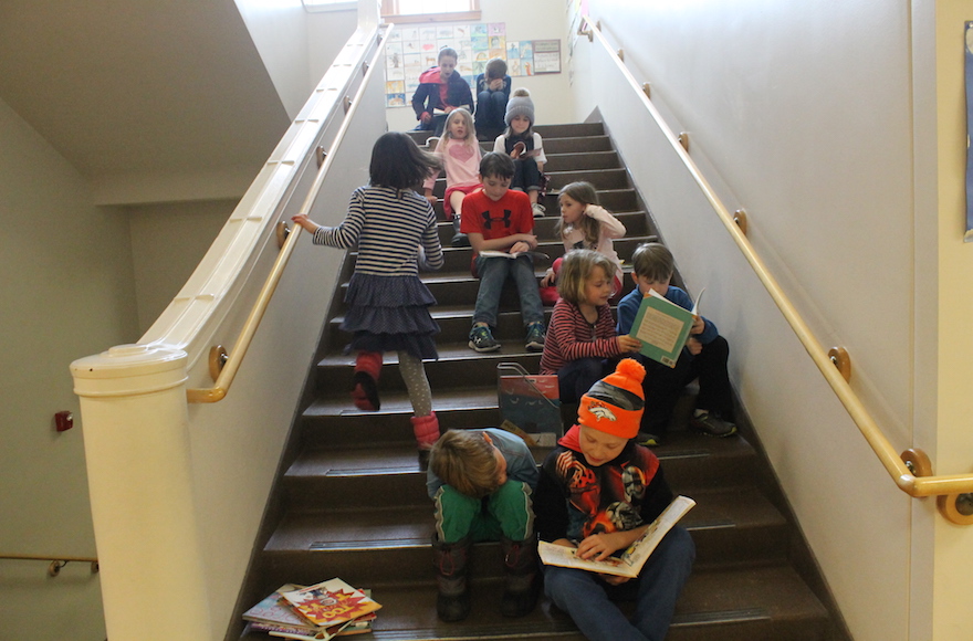 At least once a month at the McGillis School, older students take time out of the day to read stories to younger students. (Uriel Heilman)