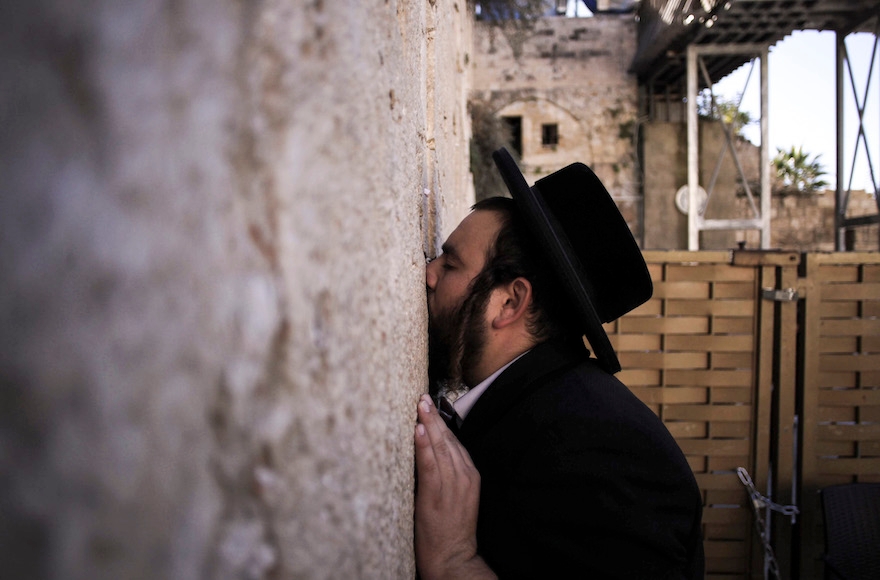 A haredi Jewish man praying at the Western Wall in the Old City of Jerusalem, Israel, Dec. 9, 2015. (Muammar Awad/Flash90)