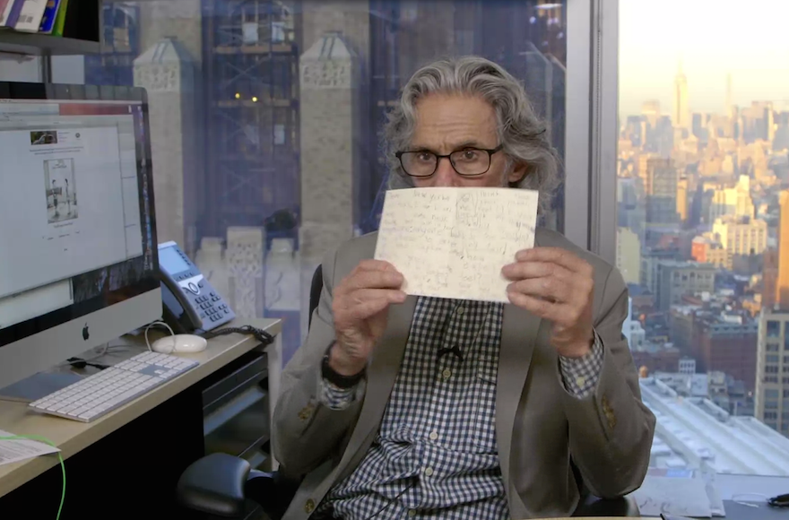 New Yorker cartoon editor Bob Mankoff in his office holding a letter from Jill Jacobs' daughter. (Screenshot from The New Yorker)