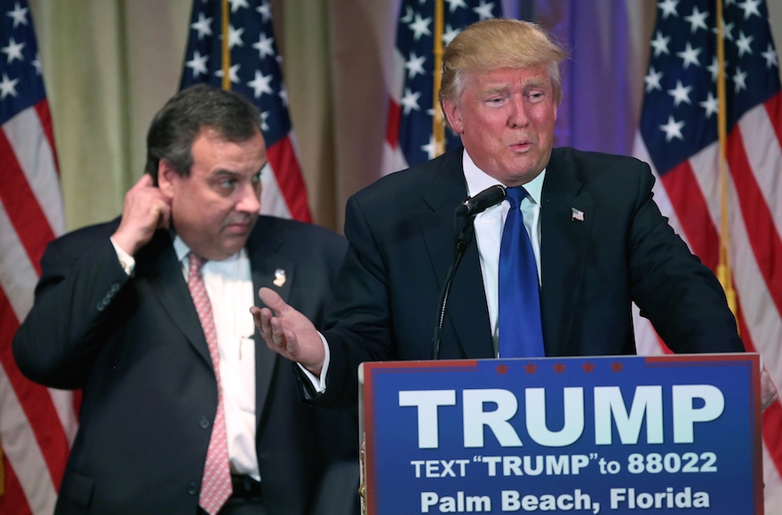 Donald Trump, right, speaking at a press conference with New Jersey Gov. Chris Christie in Palm Beach, Florida, March 1, 2016. Christie stood by, often distracted, as Trump held a press conference at his Mar a Lago Club after the polls closed on Super Tuesday. (Photo by John Moore/Getty Images)