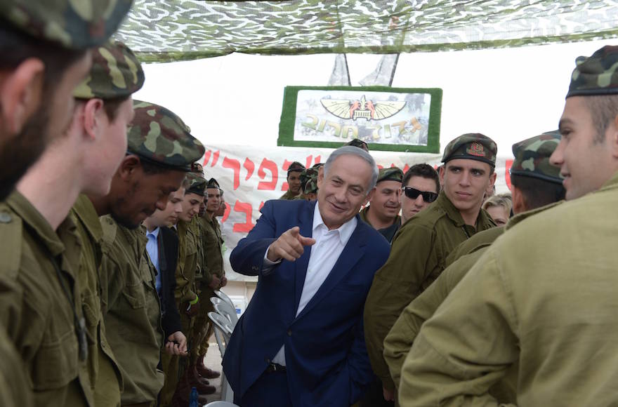 Prime Minister Benjamin Netanyahu visiting soldiers of the Kfir battalion in the Etzion regional brigade for Purim, in the West Bank, March 24, 2016. (Amos Ben Gershom/Flash90)