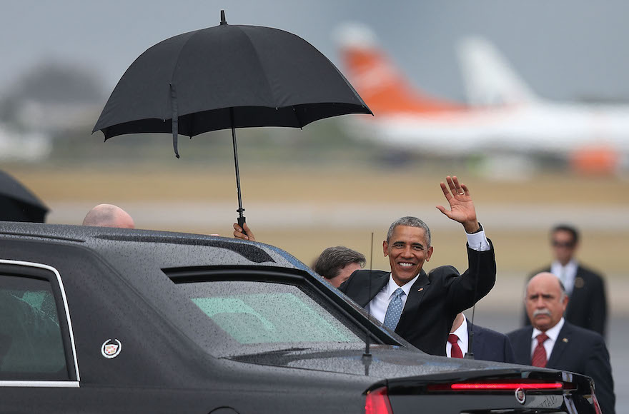 Barack Obama waving as he arrives at Jose Marti International Airport on Air Force One for a 48-hour visit in Havana, Cuba, March 20, 2016. (Joe Raedle/Getty Images)