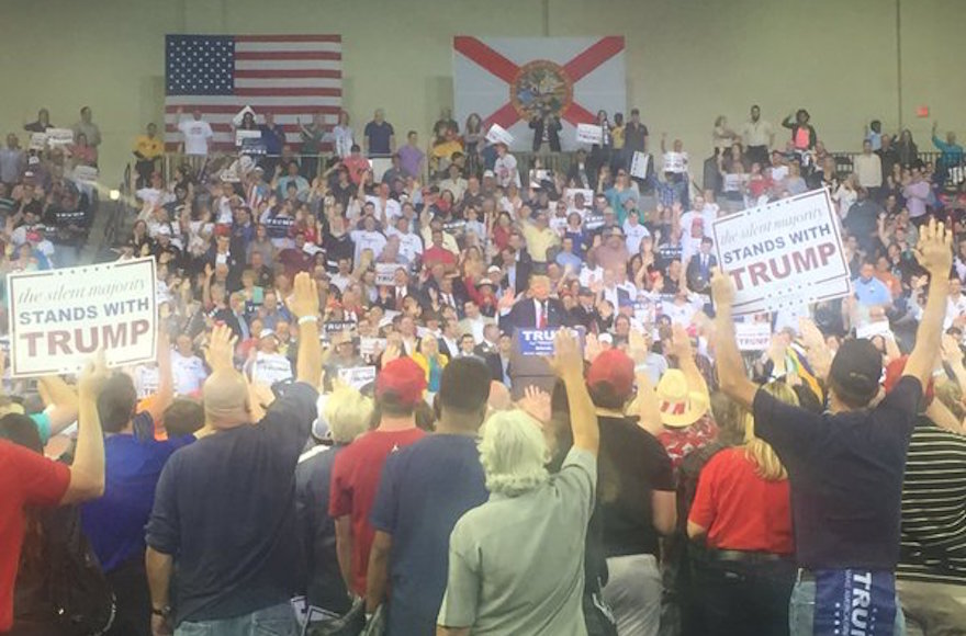 Donald Trump supporters raising their hands and reciting a pledge at their candidate's urging at a rally in Orlando, Florida. (Twitter)