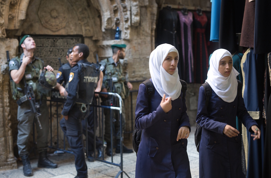 Palestinian women passing an Israeli police checkpoint in Jerusalem, Oct. 8, 2015. (MENAHEM KAHANA/AFP/Getty Images)