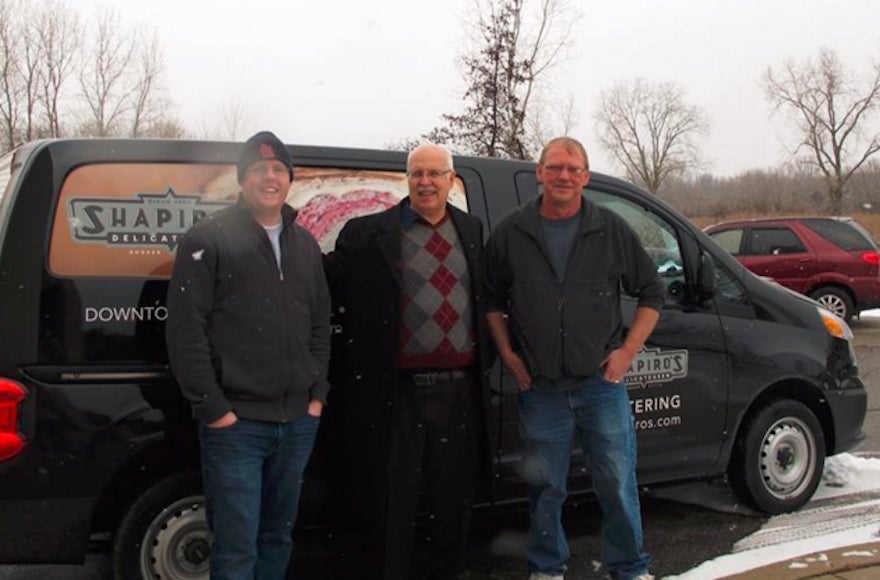 Steve Low, center, the director of the Flint Jewish Federation, takes a delivery of food from a kosher deli in Indianapolis. (Courtesy of Flint Jewish Federation)