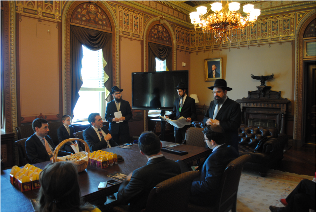 Matt Nosanchu, seated, left attends a Purim Megillah reading at the Diplomatic Reception Room on March 24. (White House)