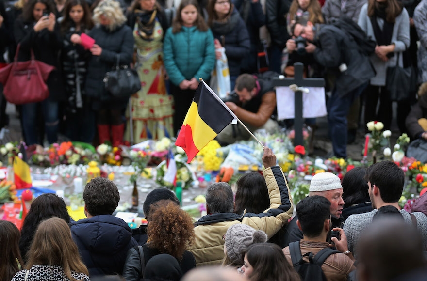 People view tributes at Place De La Bourse in Brussels to the victims of the March 22 terrorist attack at the city's airport, March 23, 2016. (Christopher Furlong/Getty Images)