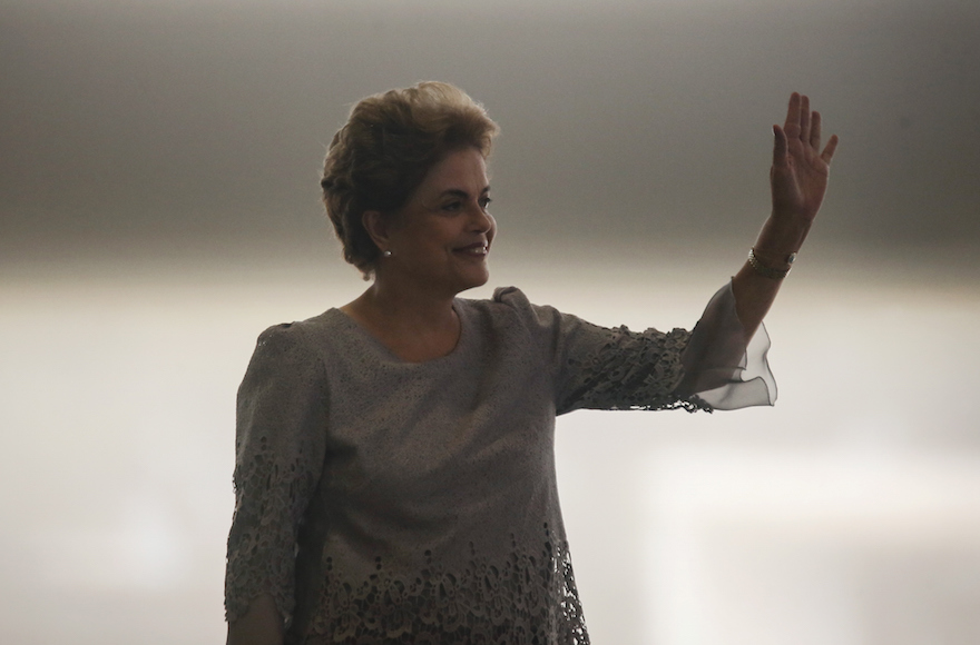 Brazilian President Dilma Rousseff waving to the crowd as she enters a meeting with supporters from the legal community at the Planalto presidential palace in Brasilia, Brazil, March 22, 2016. (Mario Tama/Getty Images)