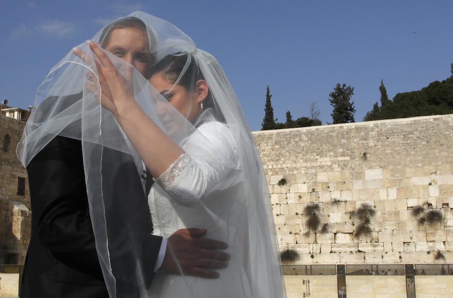 Groom and bride taking wedding pictures at the Western Wall in Jerusalem, April 13, 2011. (Nati Shohat/Flash90)