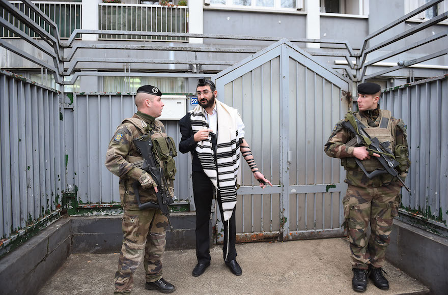 Soldiers guarding a staff member at a Chabad school in Paris, Nov. 16, 2015. (Israel Bardugo/Courtesy of the International Fellowship of Christians and Jews)