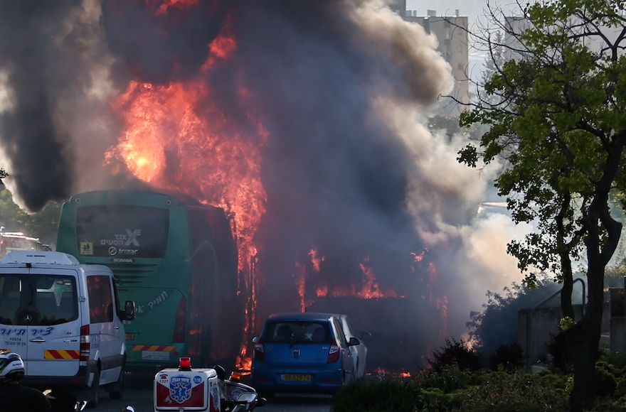 Firefighters and rescue personnel at the scene of a bus bombing in the Talpiot neighborhood of Jerusalem, April 18, 2016. (Nati Shohat/Flash90)