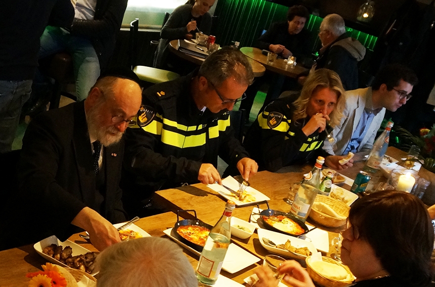 Dutch Chief Rabbi Binyomin Jacobs left and police representatives at Grand Cafe Rimon in Amsterdan on May 24, 2016. (Cnaan-Liphshiz)