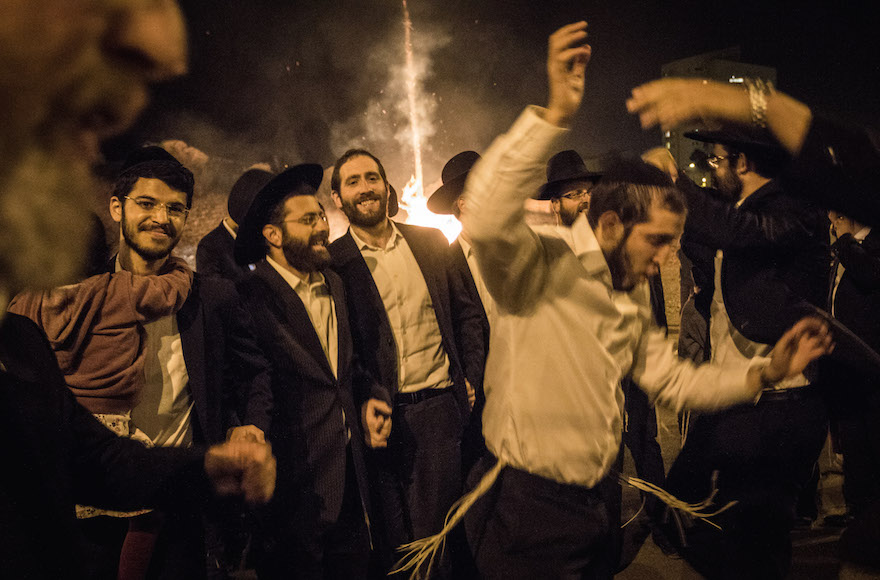 Haredi Orthodox Jews dancing near a bonfire during celebrations of the Jewish holiday of Lag Ba'Omer in Jerusalem, May 25, 2016. (Zack Wajsgras/Flash90)