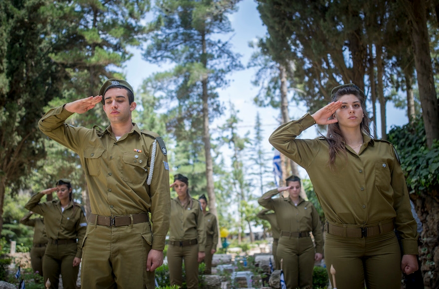Israeli soldiers saluting during the flag-laying ceremony ahead of Memorial Day at the Mount Herzl military cemetery in Jerusalem, April 8, 2016. (Yonatan Sindel/Flash90) 