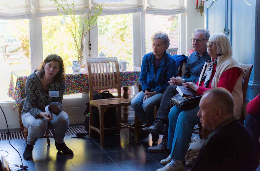 Yvonne van Gennep-Bouma, left, telling visitors about a Jewish family that once lived at what is now her home in the Hague, May 1, 2016. (Cnaan Liphshiz)