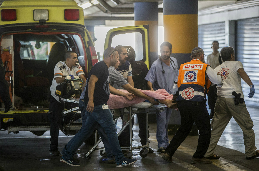 Medics wheel Hallel Yaffa Ariel, 13,who was stabbed by a Palestinian attacker in the bedroom of her Kiryat Arba home, into the emergency room of the Shaare Zedek Medical Center on June 30, 2016. She died of multiple stab woudns. (Photo by Yonatan Sindel/Flash90)