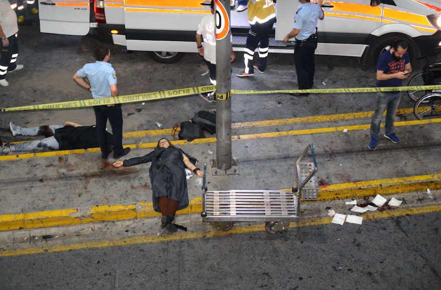 EDITORS NOTE: Graphic content / This picture obtained from the Ilhas News Agency shows ambulances and police intervening next to injured people lying on the ground, after two explosions followed by gunfire hit the Turkey's biggest airport of Ataturk in Istanbul, on June 28, 2016. At least 10 people were killed in a suicide attack at the international terminal of Istanbul's Ataturk airport, June 28, 2016. (AFP/Getty Images)